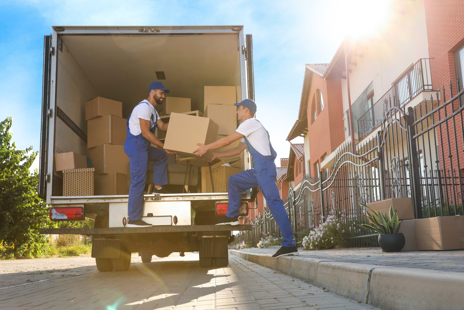 Workers,Unloading,Boxes,From,Van,Outdoors